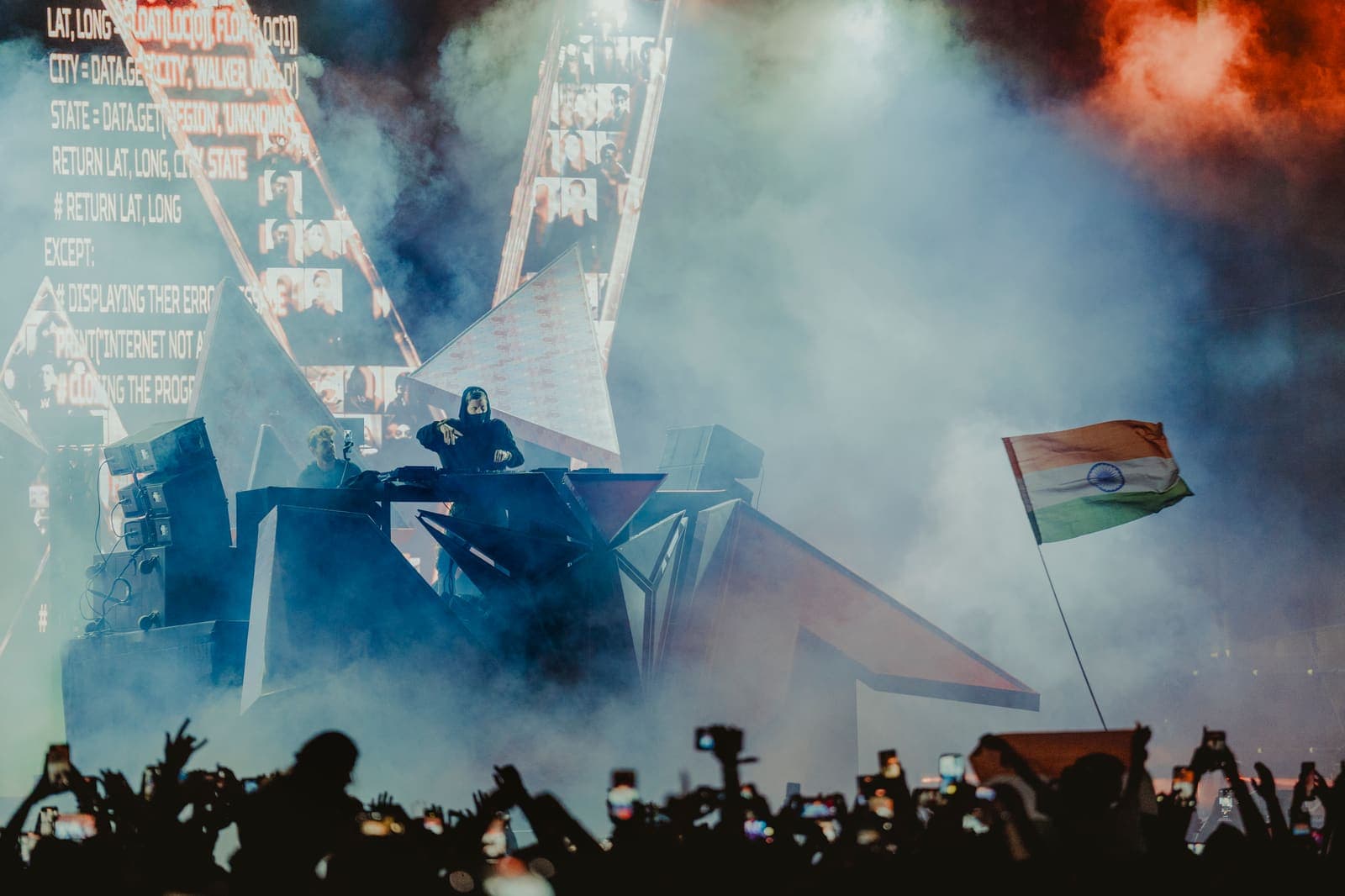 Smoky festival stage with waving flags