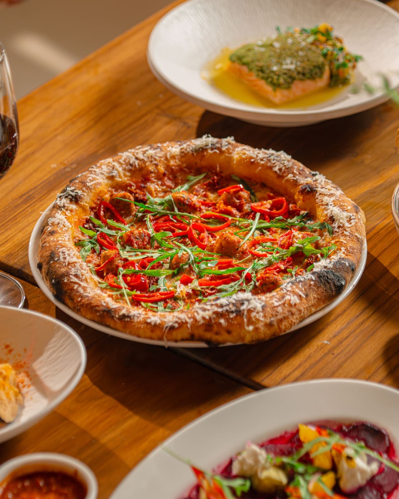Wood-fired pizza with fresh plates