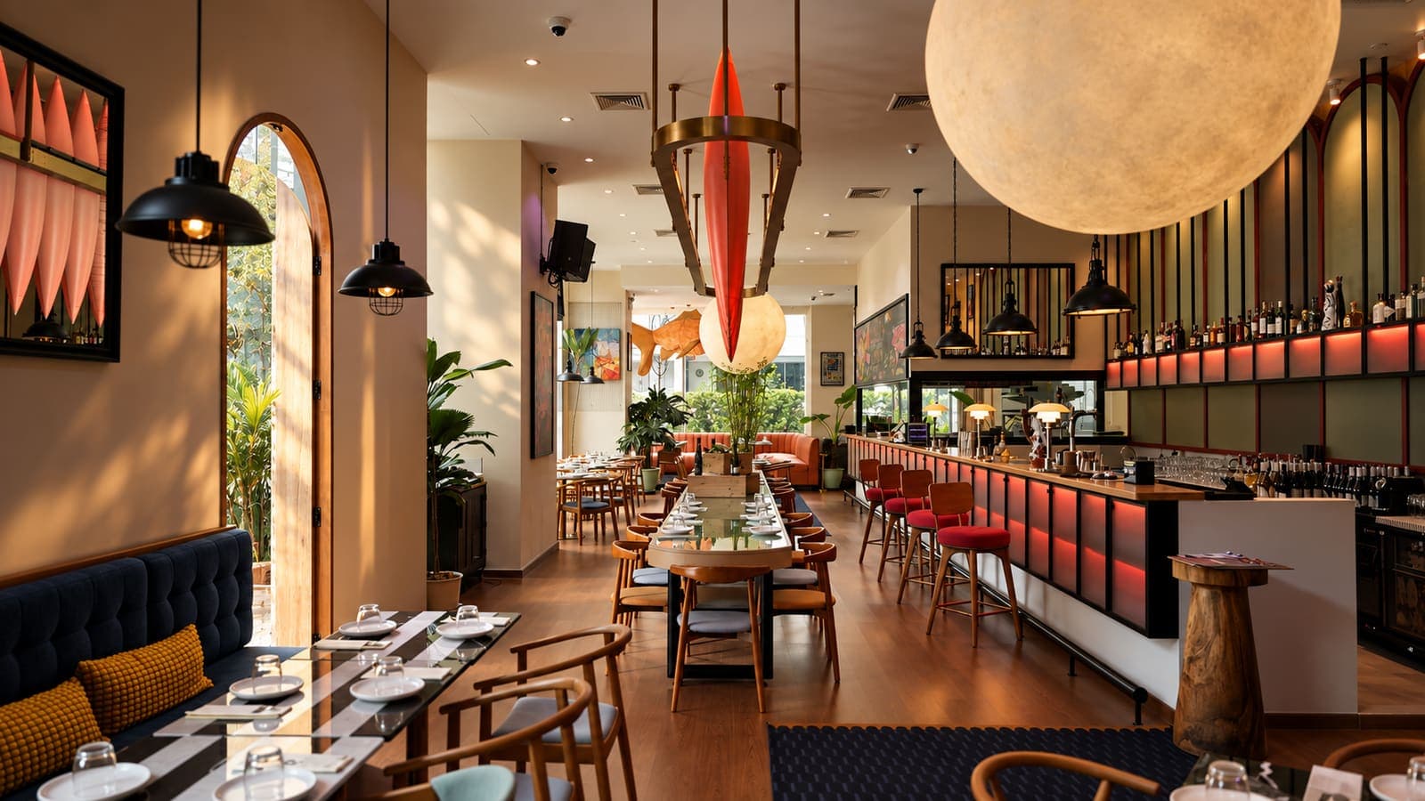 Warm restaurant interior with bar seating and pendant lights
