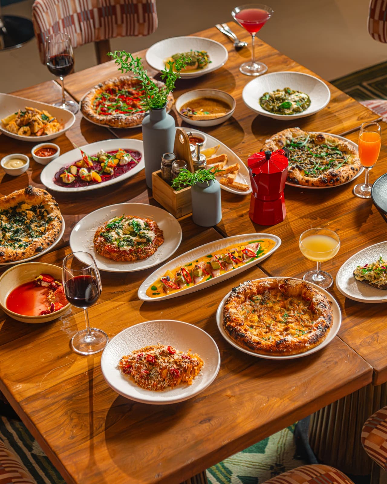 Table of shared dishes and cocktails