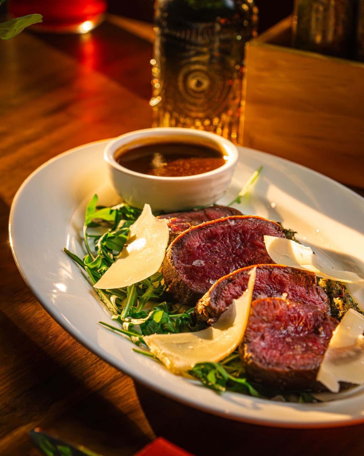 Seared steak with parmesan in low candlelight