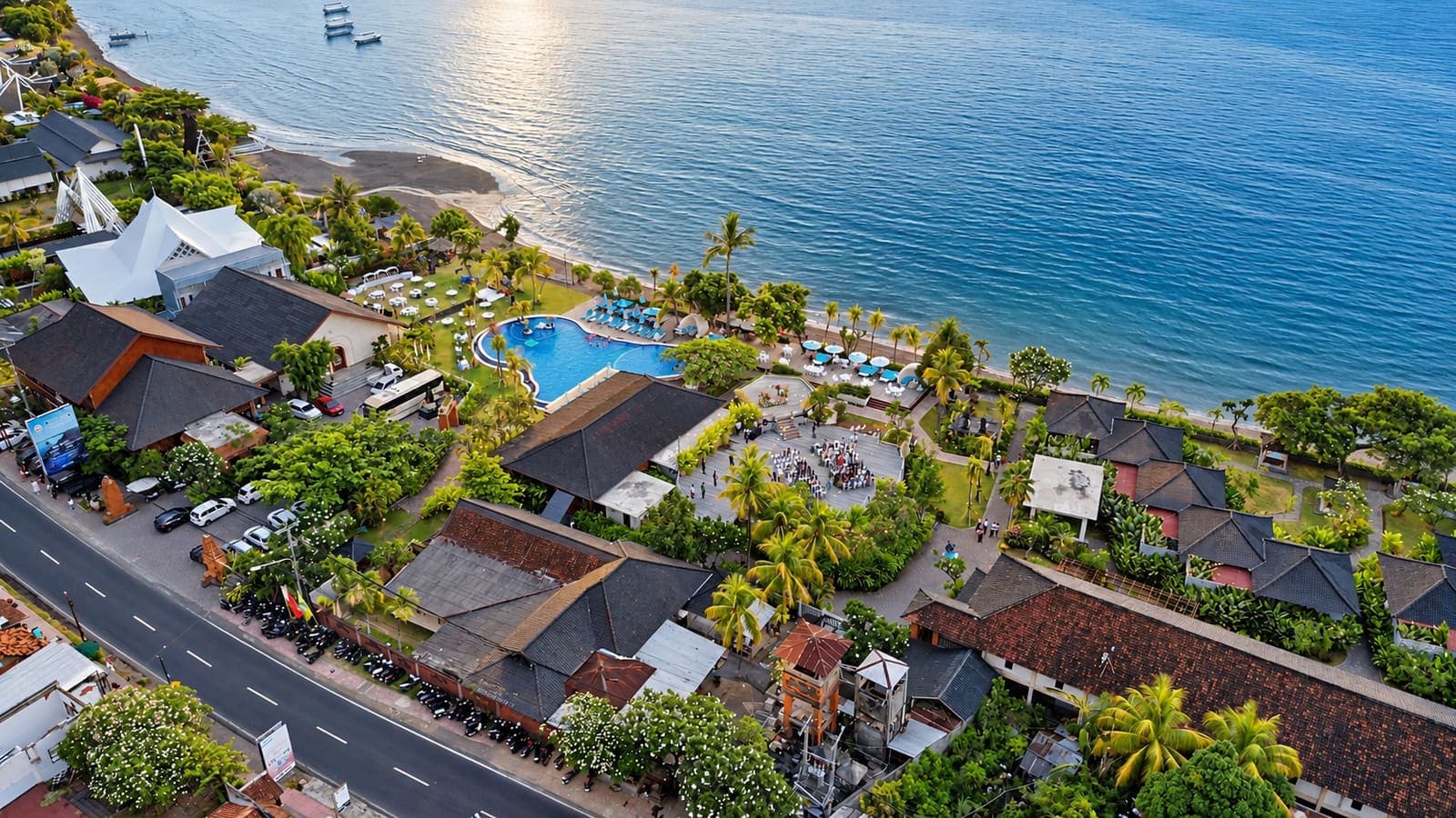 Aerial view of a beachfront resort and pool on the Bali coast